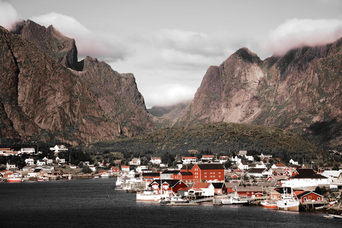 Red fishing cottages below the peaks of Lofoten